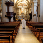 Priest in an empty church. Religious attendance By GodongPhoto/stock.adobe.com
